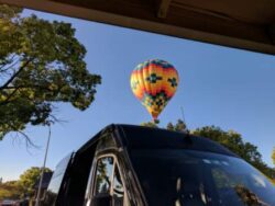 The hot air balloon lands in Alston Park in Napa California. Master Wine Tours waits with the Mercedes sprinter to pickup when they land.