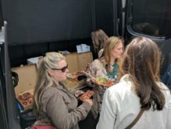 The girls share pizza from the Sprinter trunk of Master Wine Tours, Napa valley.